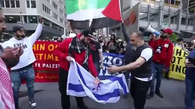 Pro-Palestine protesters burn Israeli flag as they protest attacks in New York._#46